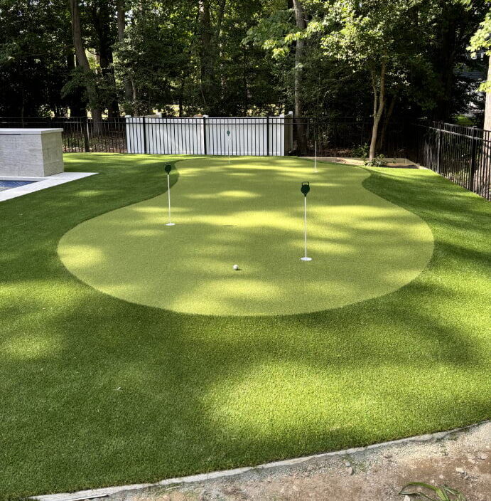 Completed synthetic turf installation showing lush green artificial grass in a Delaware backyard